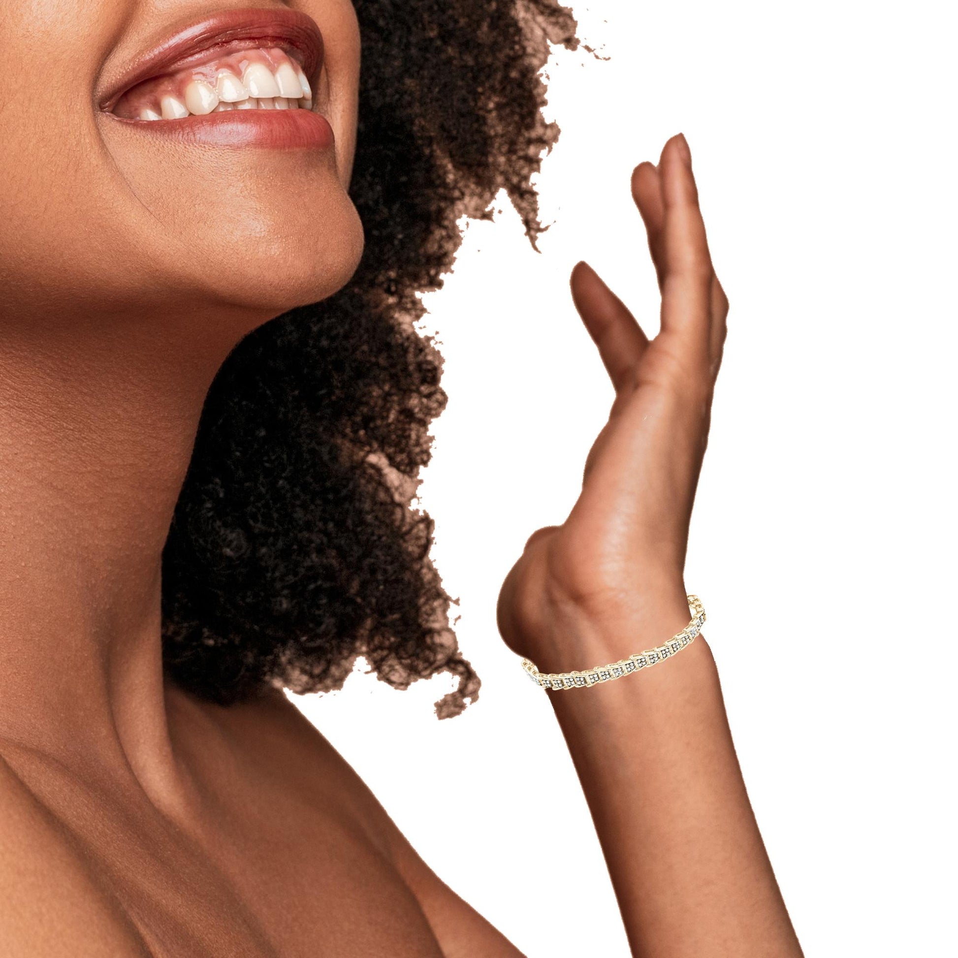 Yellow bracelet with round white gemstones in prong setting, shown on model's wrist, side angle.