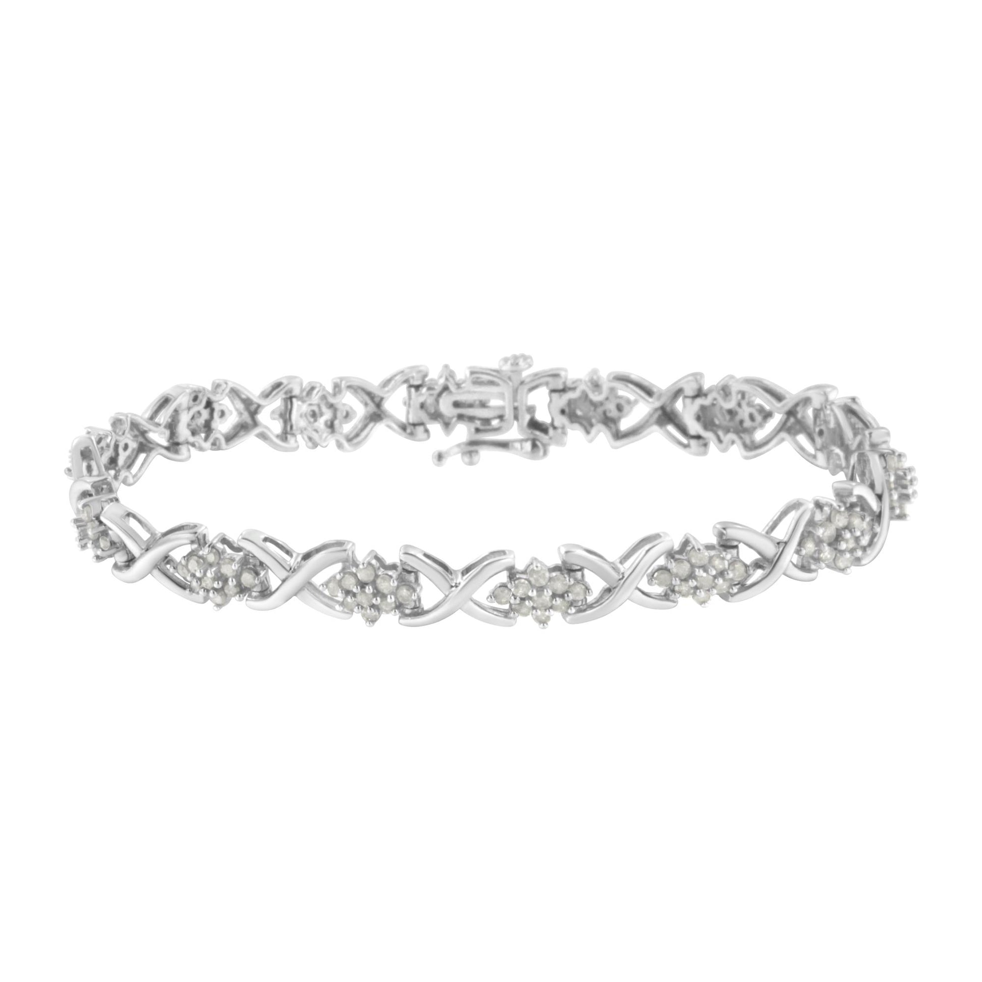 White metal bracelet with alternating twisted links and clusters of round white gemstones in prong settings, shown from a top angled view.