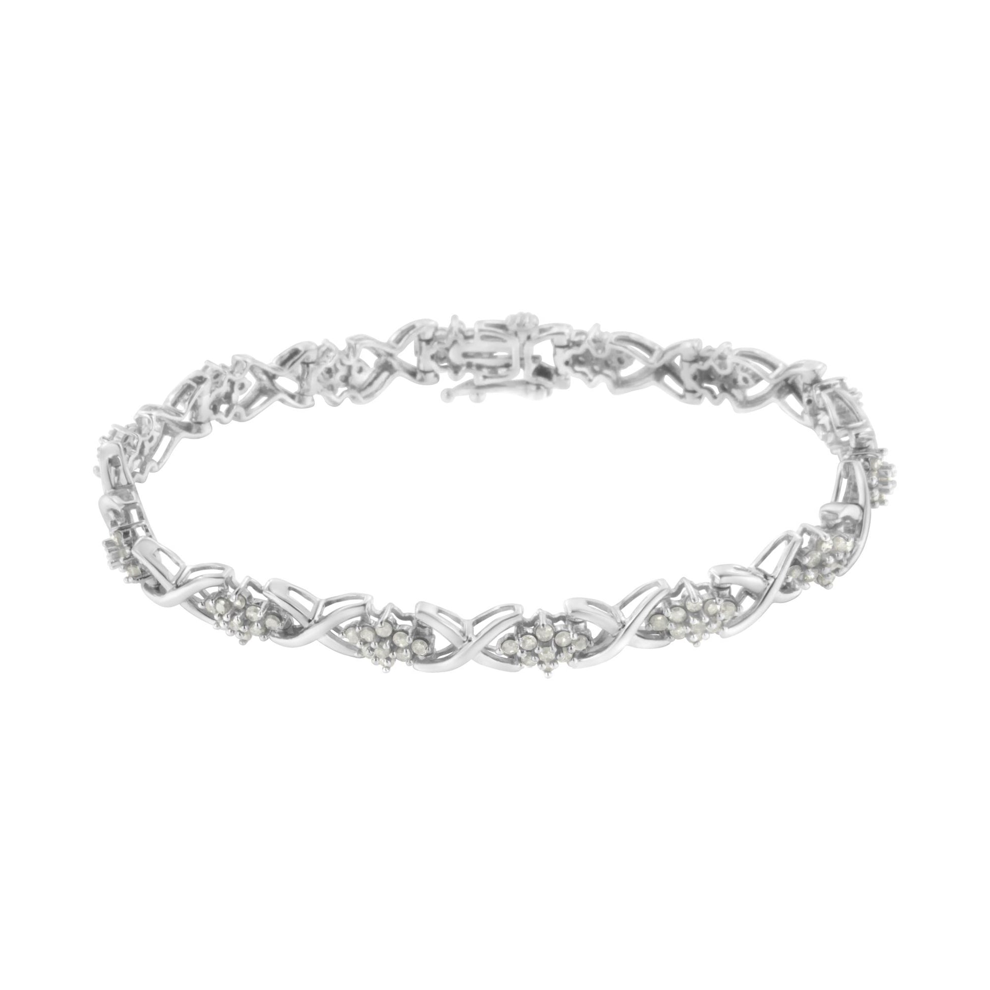 Front angled view of a white metal bracelet featuring an alternating pattern of X-shaped links and clusters of round white gemstones in prong settings.