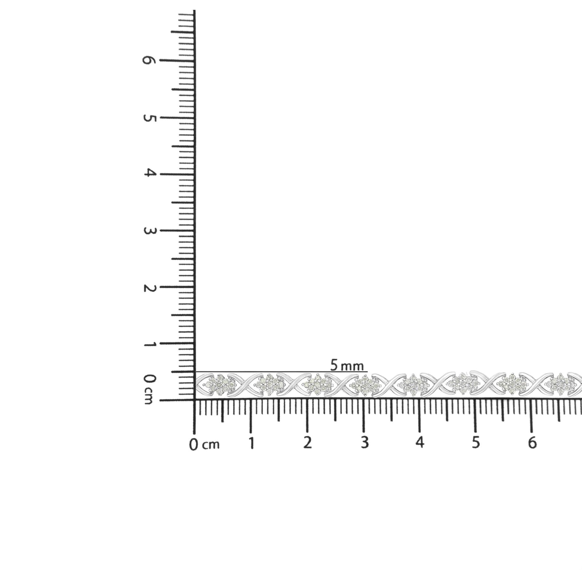 White metal bracelet with round white gemstones in prong settings, placed on ruler for size reference, front view.