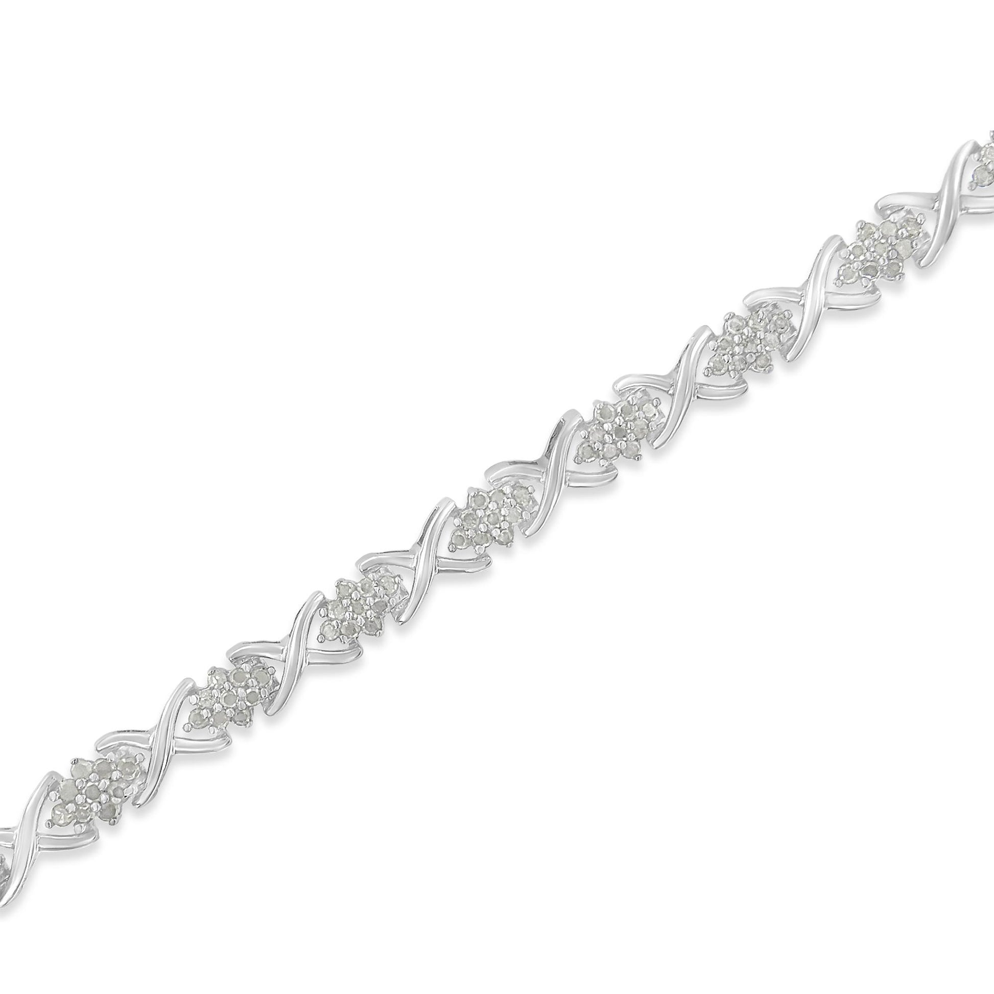 White metal bracelet with alternating clusters of round white gemstones and X-shaped links, shown in a diagonal close-up shot.