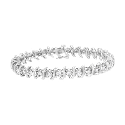 White metal bracelet with round prong-set white gemstones in alternating sizes, shown from a slight top front angle.