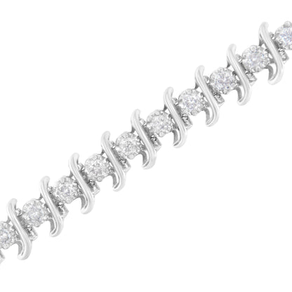 Close-up diagonal view of a white metal bracelet featuring alternating round white gemstones in prong settings.