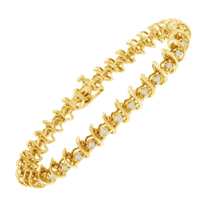 Yellow metal bracelet with round white gemstones set in prongs, shown from a top angled view.