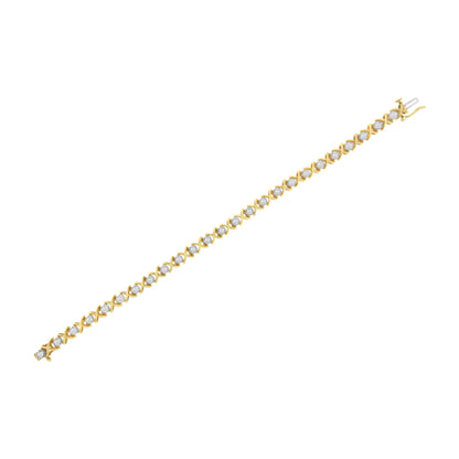 Yellow metal bracelet with round white gemstones in prong settings, shown in a flat lay from a top angle.