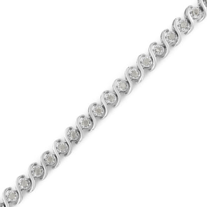 White metal bracelet with round white gemstones set in a wave pattern, shown in a close-up diagonal angle.