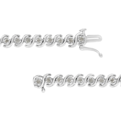 Close-up front view of a white metal bracelet featuring round white gemstones in a miracle setting along the chain, with the clasp open.