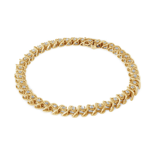 Yellow metal bracelet with round white gemstones in a miracle setting, shown from a top angled view.
