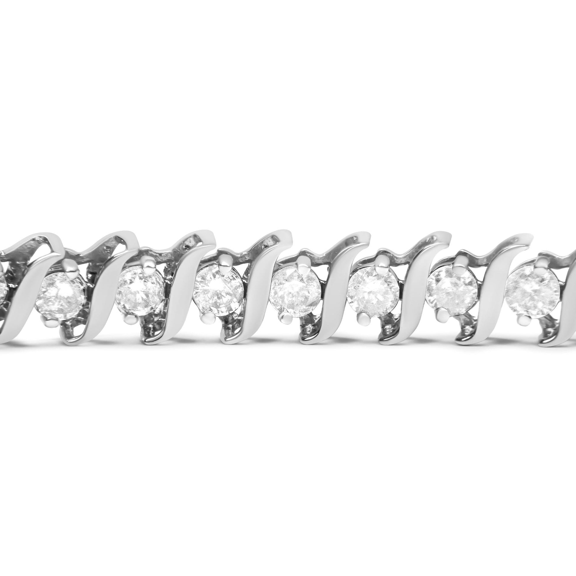 Close-up front angle of a white bracelet featuring round white gemstones in a two-prong setting.