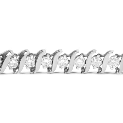 Close-up front angle of a white bracelet featuring round white gemstones in a two-prong setting.