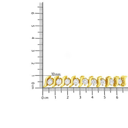 Close-up of a yellow metal bracelet with round prong-set brownish gemstones, displayed on a ruler for size reference.