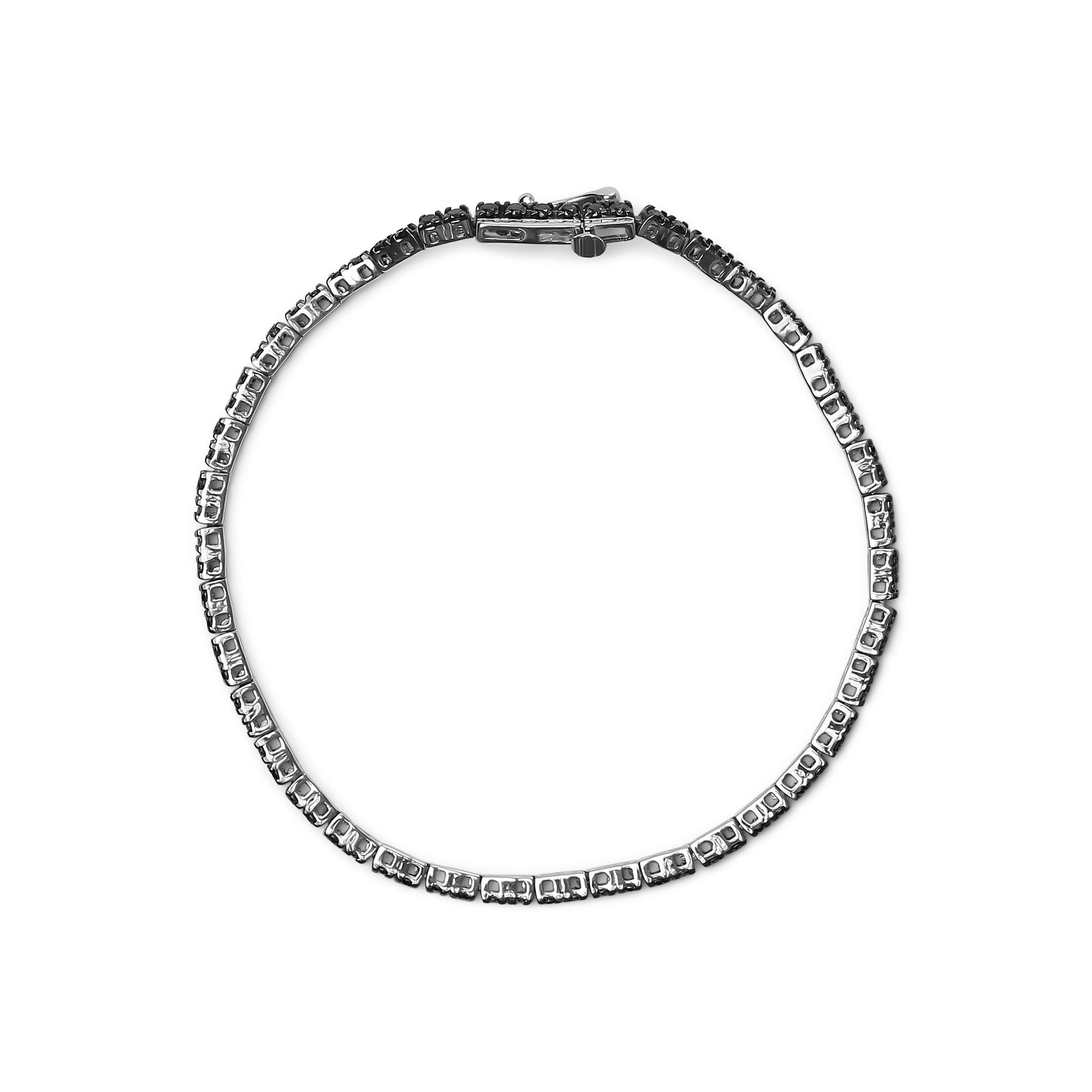 Top-down view of a white metal bracelet with round black gemstones in prong settings.