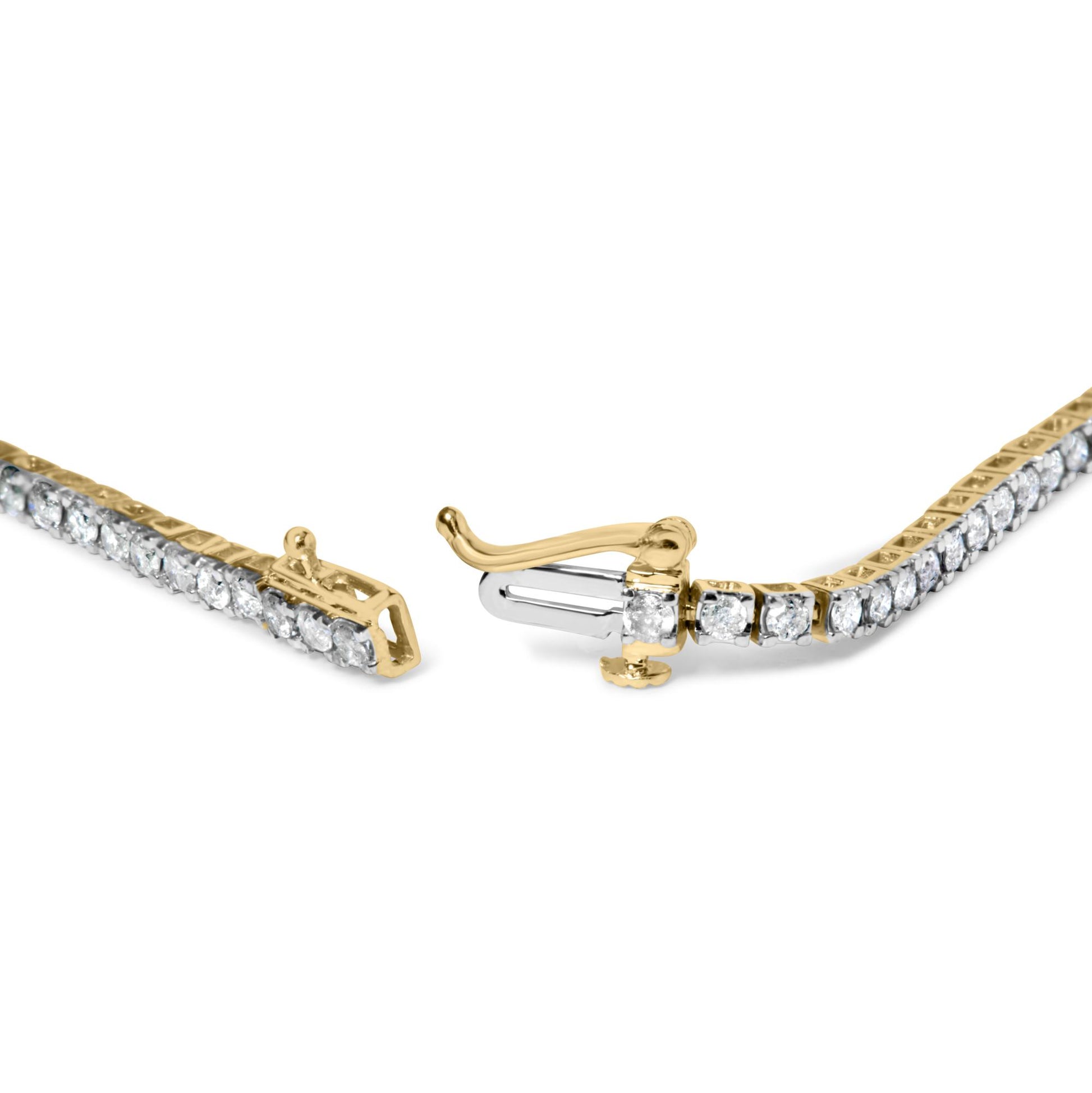 Close-up angled view of a yellow bracelet with round brownish gemstones in 4-prong settings and an open clasp.