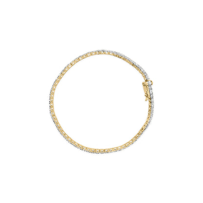 Top-down view of a yellow metal bracelet with round brownish gemstones set in four-prong settings all around, shown against a white background.