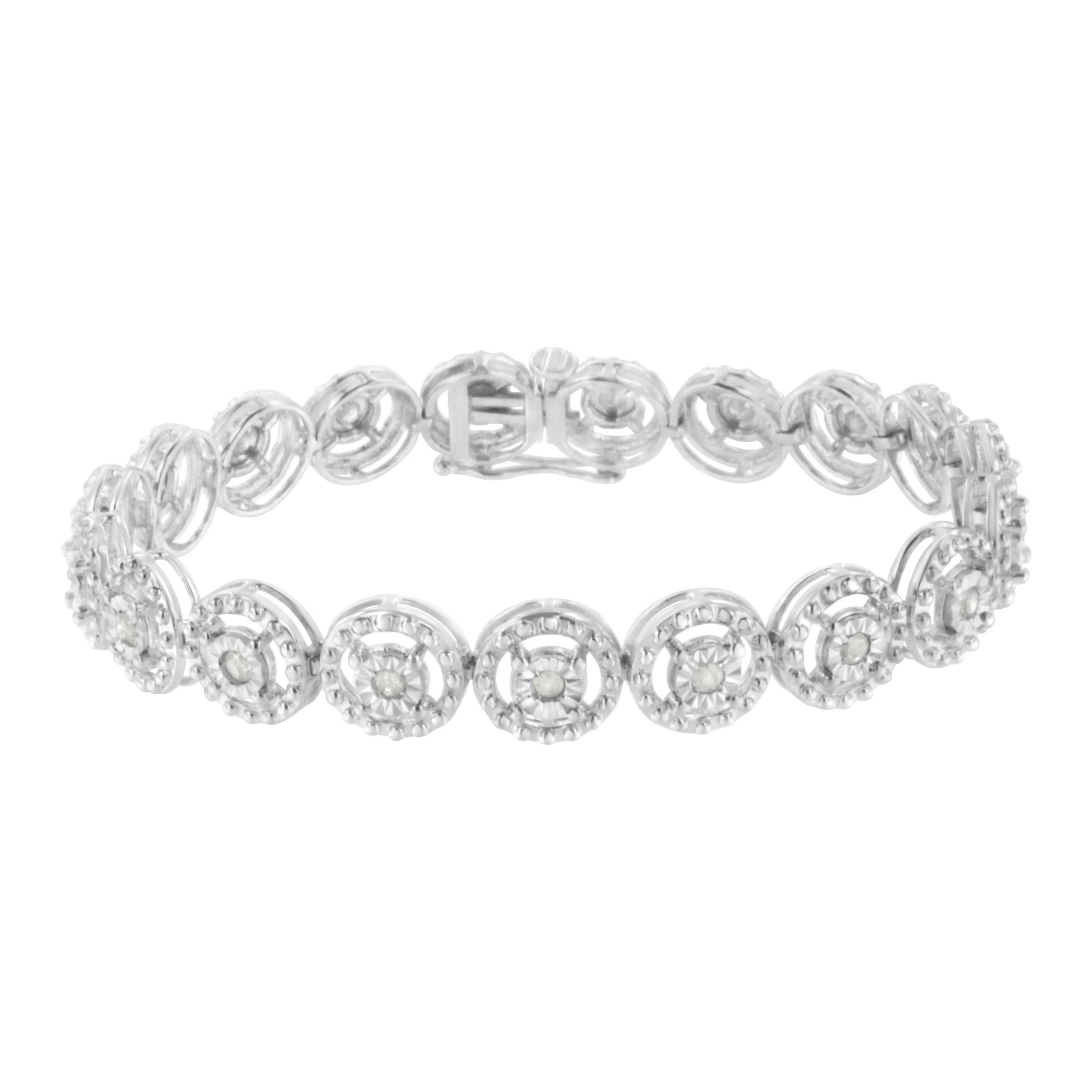 White metal bracelet viewed from a slight angle, featuring round white gemstones in prong settings arranged in circular linked patterns.