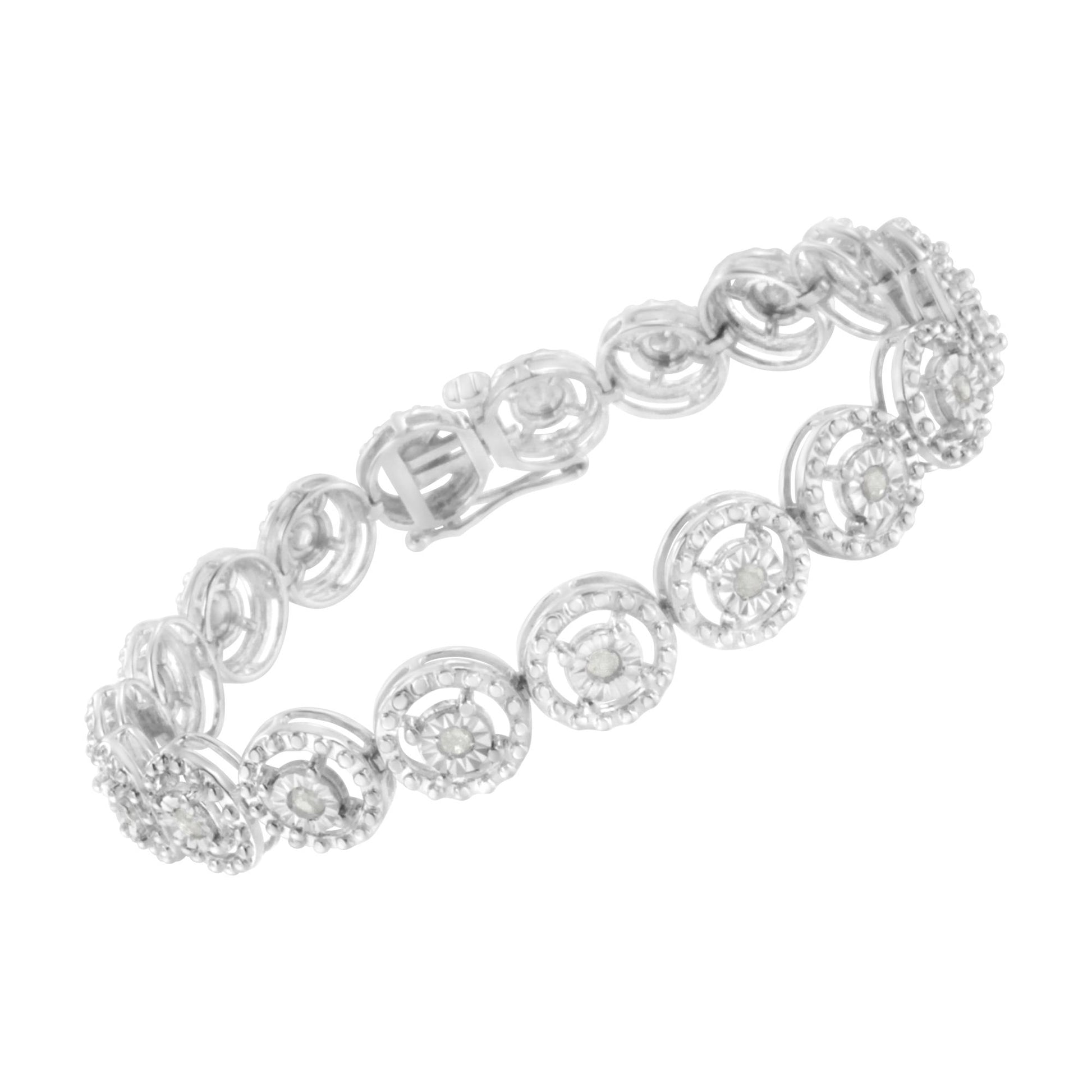 White metal bracelet with circular links featuring prong-set round white gemstones, shown at an angled top-down view.