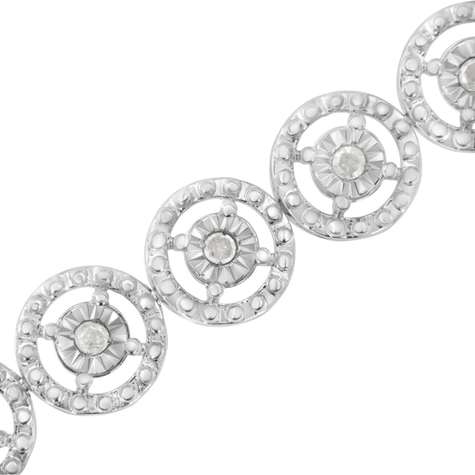 White metal bracelet with linked circular segments, each featuring a central round white gemstone in prong setting, close-up angled view.