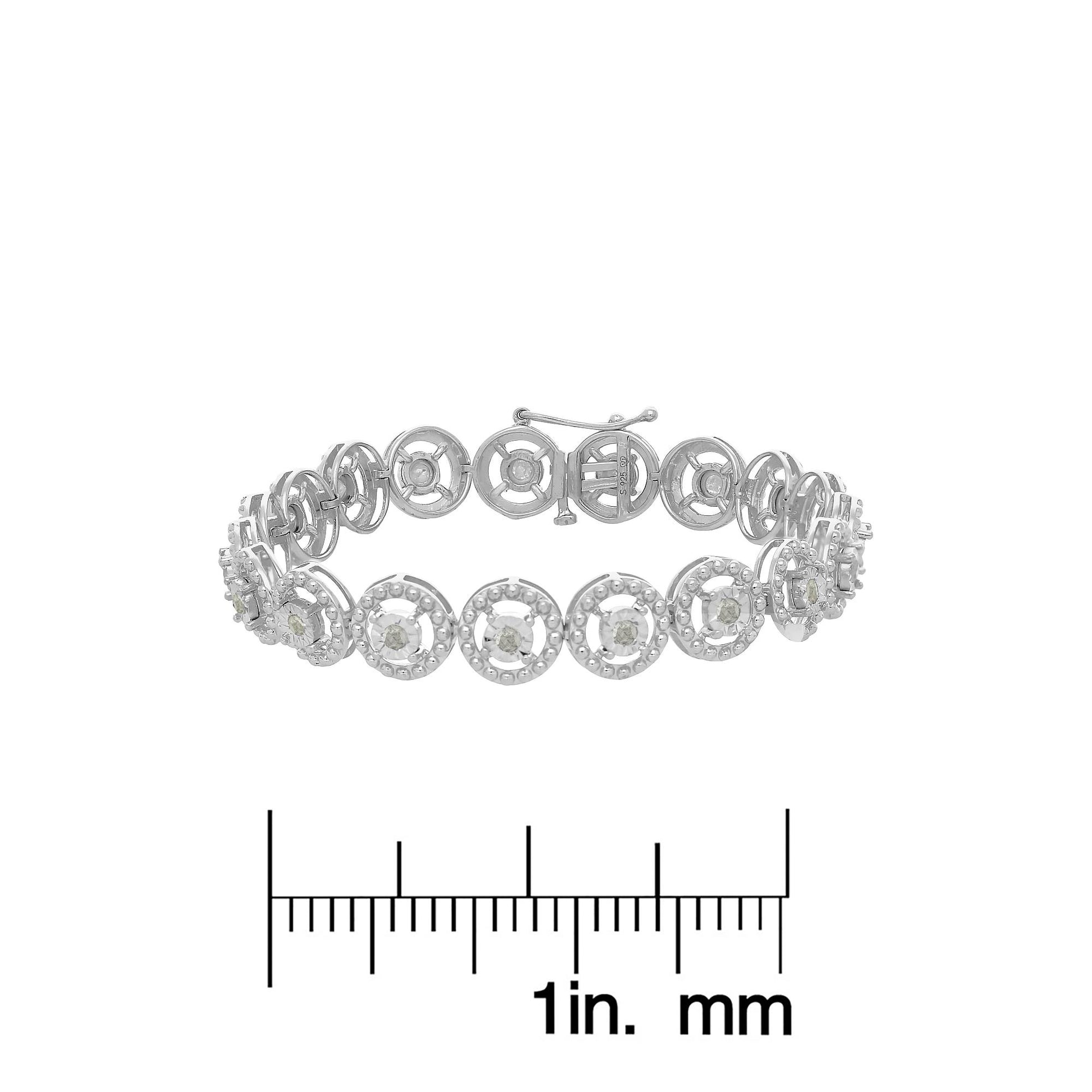 White metal bracelet with round white gemstones in prong settings, shown in a front-facing angle above a ruler for size reference.