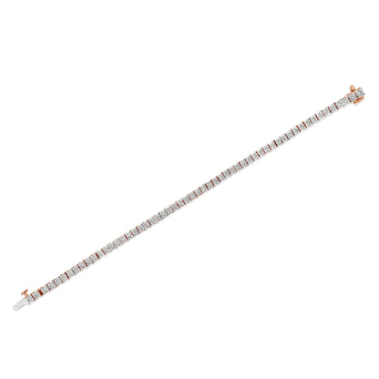 Image of a rose-colored metal bracelet featuring a row of round white gemstones in a miracle setting, shown diagonally from above on a white background.