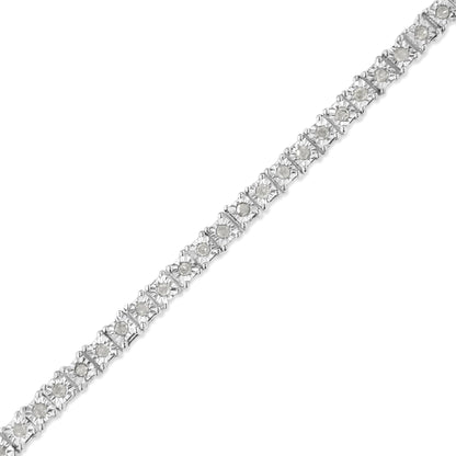 Diagonal close-up of a white metal bracelet with round white gemstones in a miracle setting.