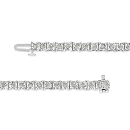 Close-up shot of a white metal bracelet with round white gemstones set in a miracle setting, shown from the top with the clasp visible.