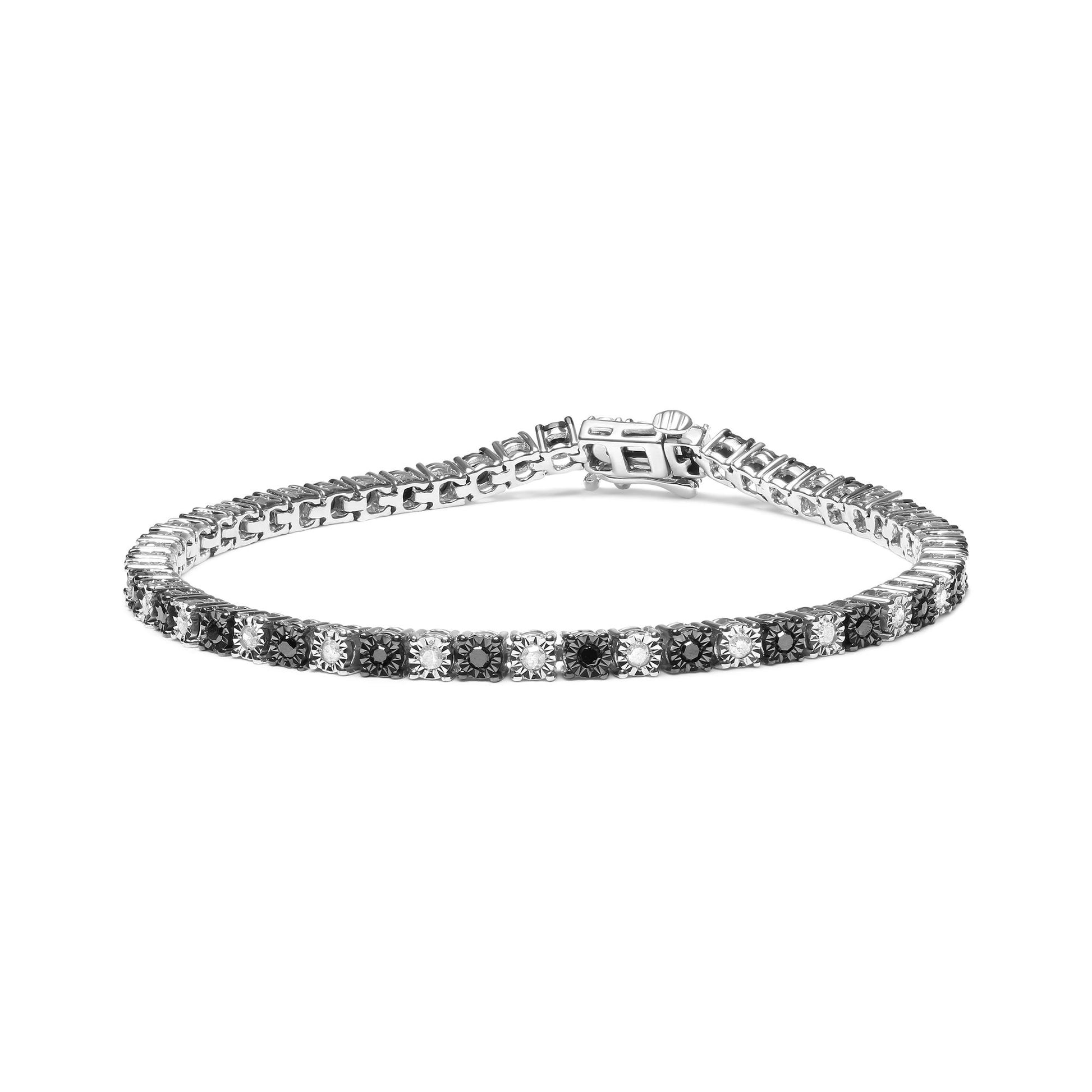 White metal bracelet with alternating black and white round and rose-shaped gemstones in miracle settings, shown from a low angled front view.