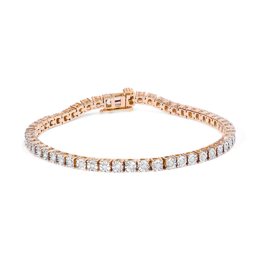 Bracelet in rose metal with a row of round white gemstones in miracle setting, photographed from an angled top view.
