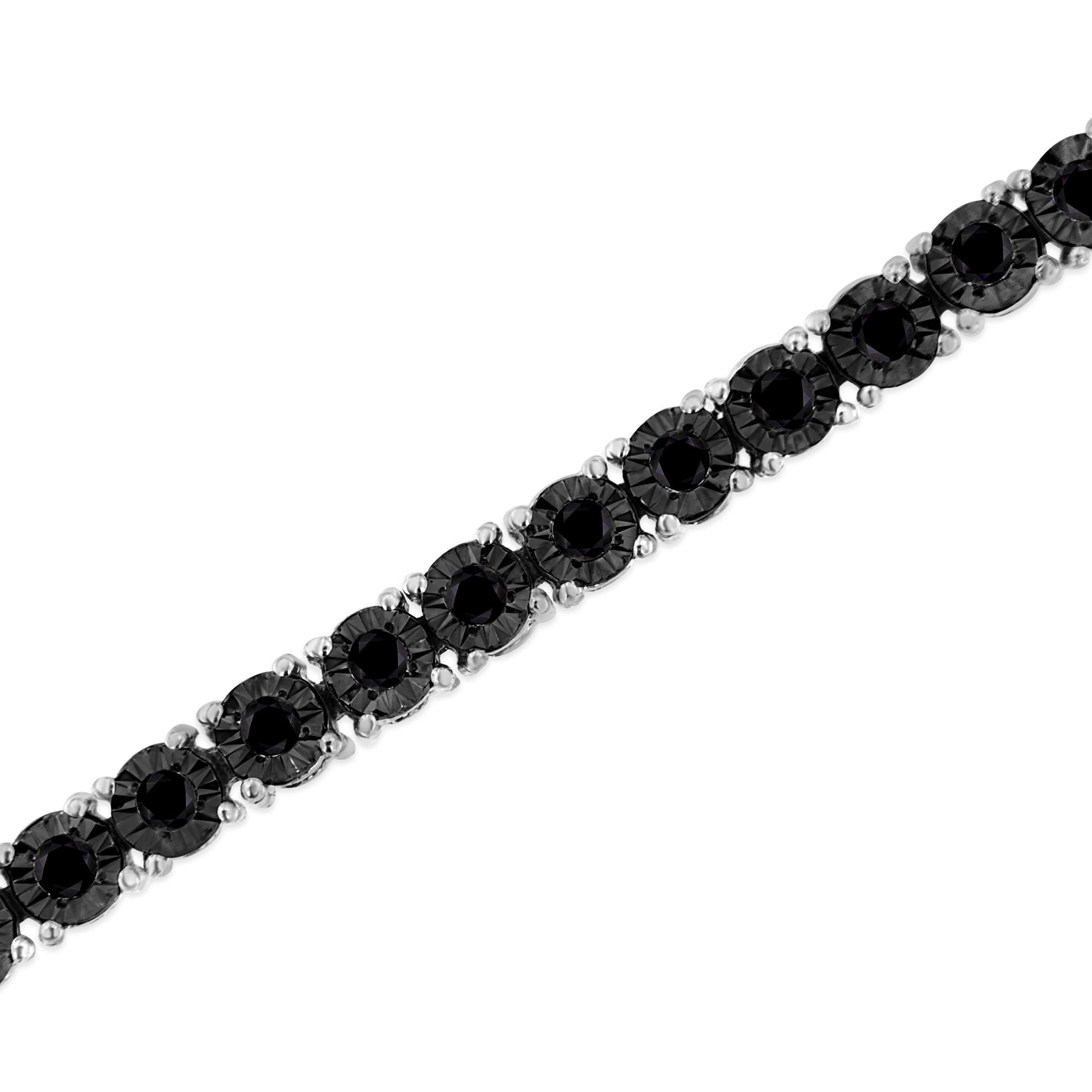 White metal bracelet with round black gemstones in miracle setting, photographed at a slight angle.