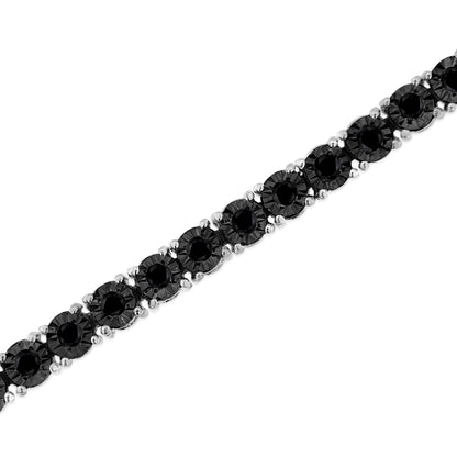 White metal bracelet with round black gemstones in miracle setting, photographed at a slight angle.