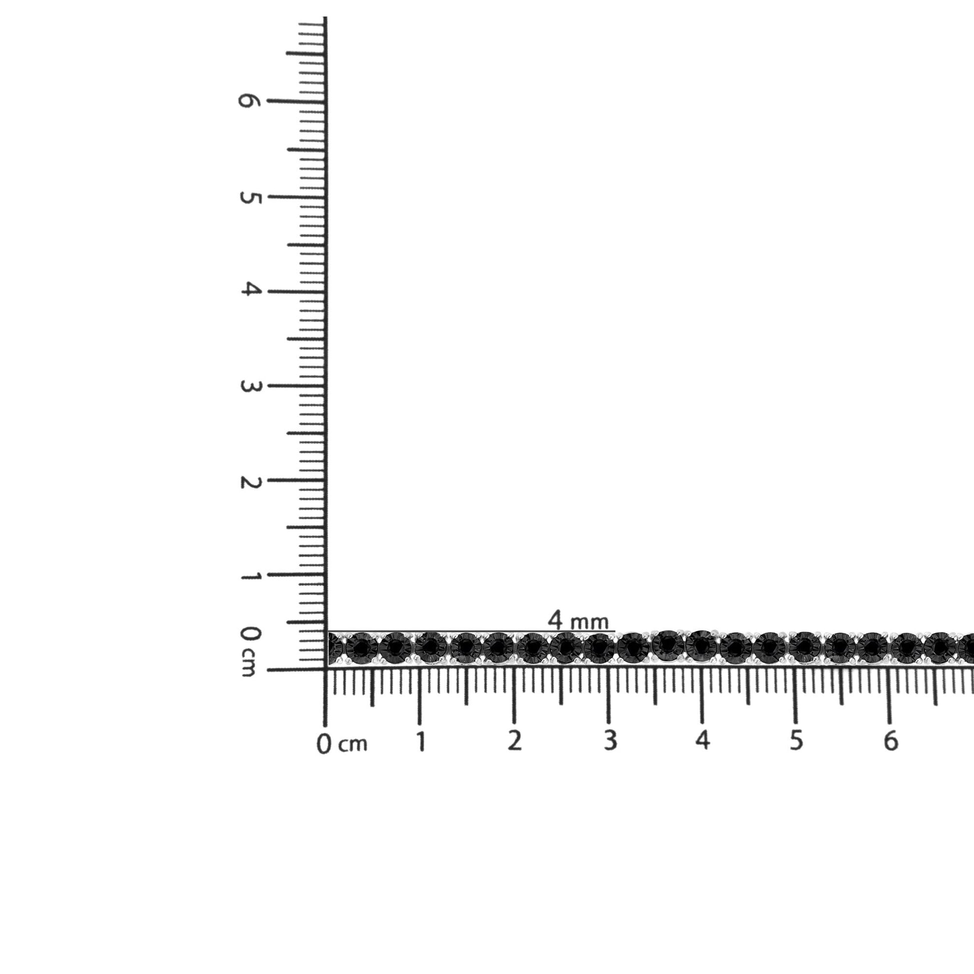 White metal bracelet with round black gemstones in a miracle setting, displayed horizontally on a ruler for size reference, top-down angle.