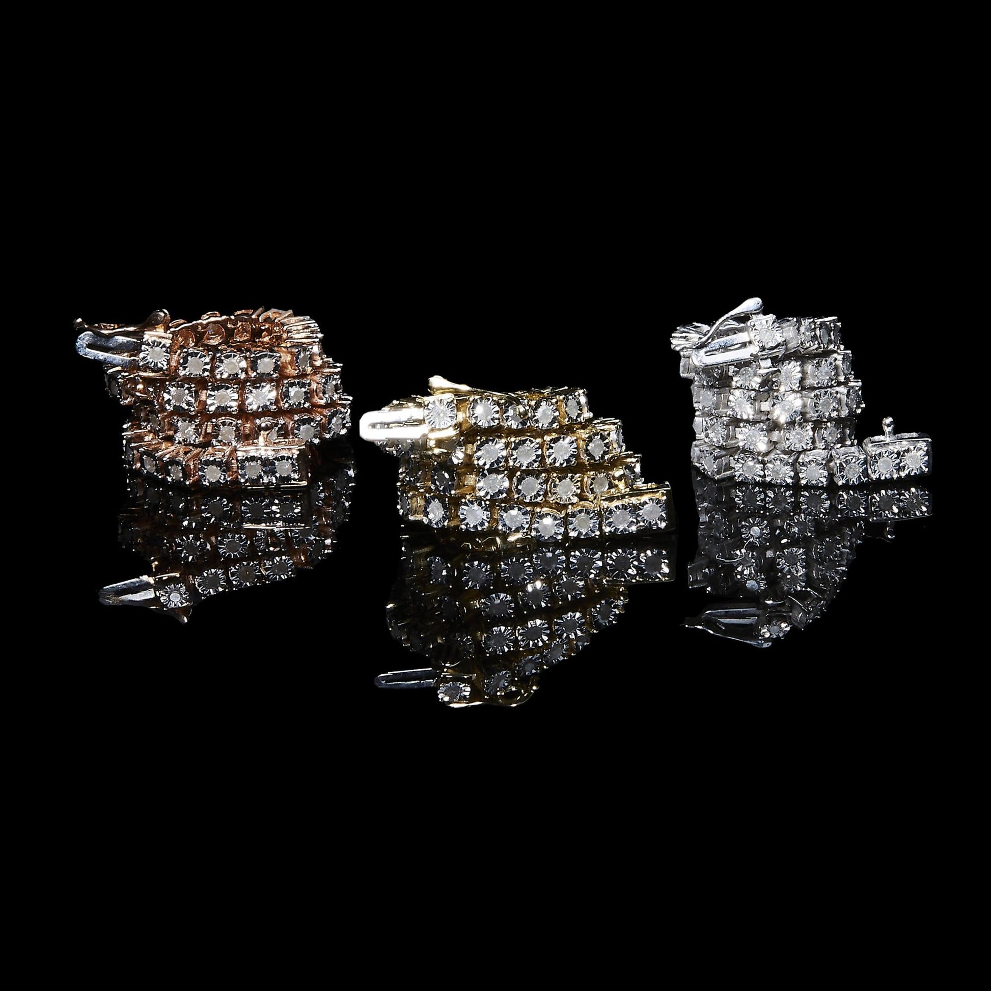 Bracelet with white metal and round white gemstones in miracle setting, shown from the front on a reflective black surface.