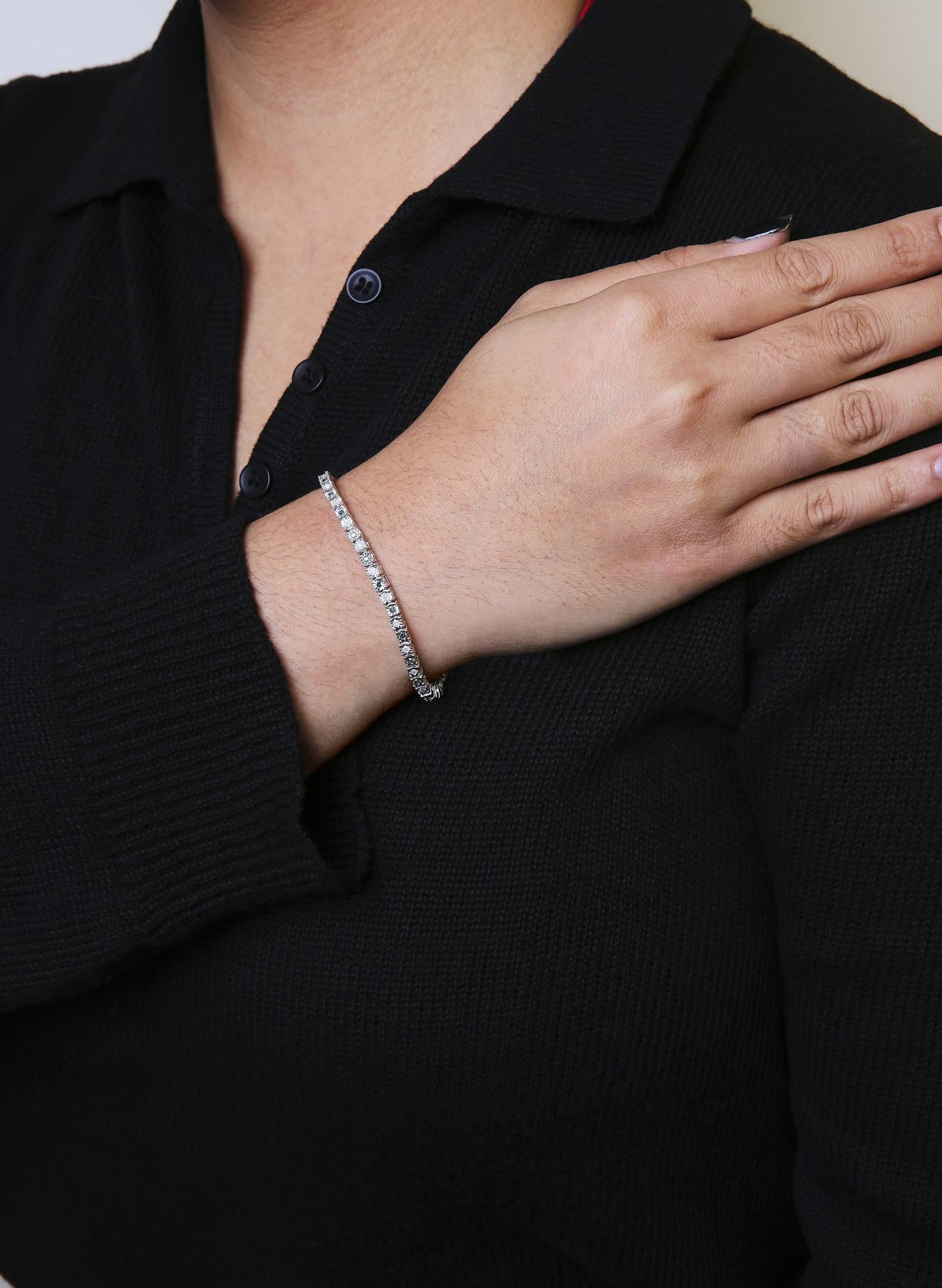 White metal bracelet with alternating round green and rose-shaped white gemstones in miracle setting, worn on a model’s wrist, shown from front angle.