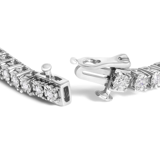 Close-up angle of a white metal bracelet with round white gemstones in miracle settings, focusing on the clasp.