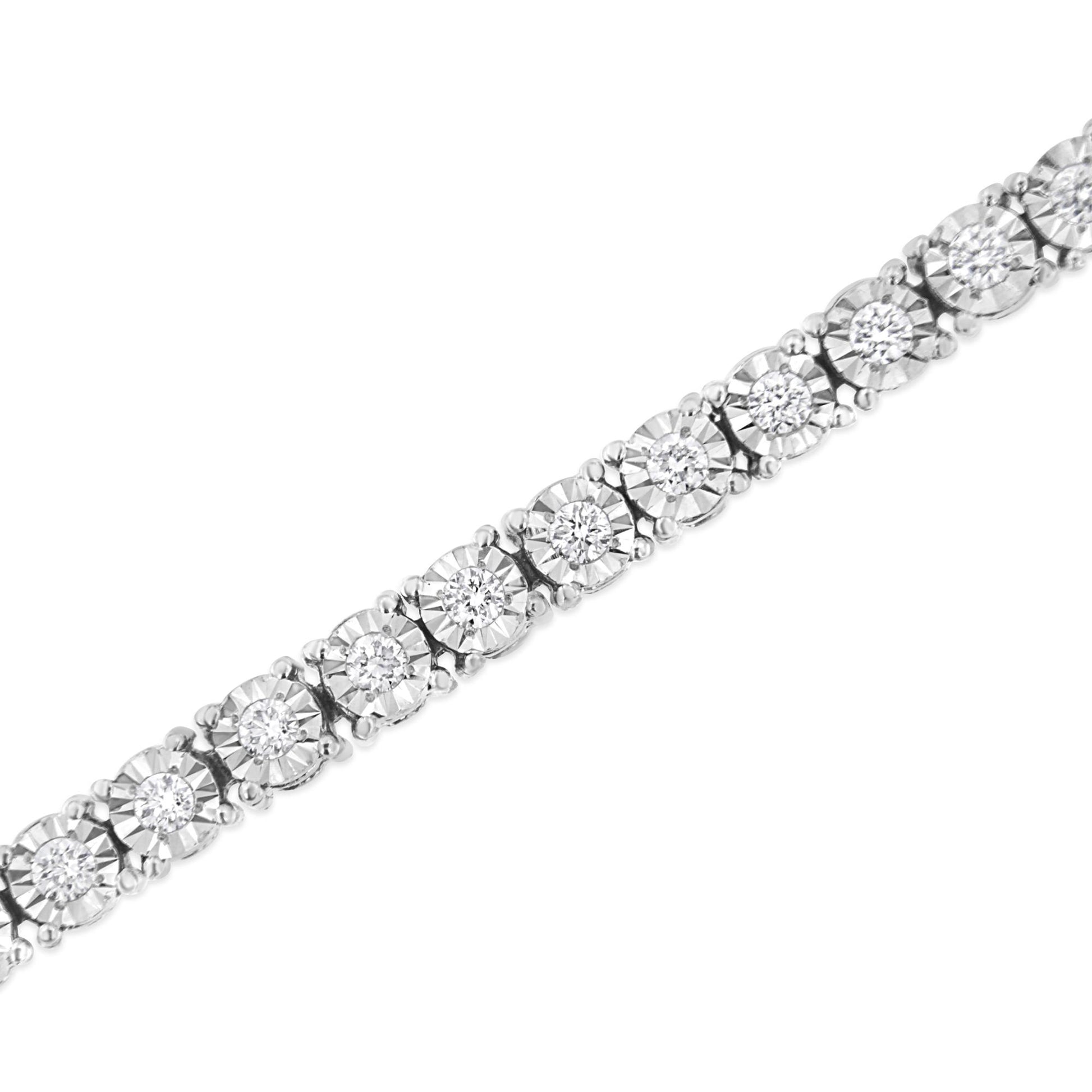Close-up diagonal view of a white metal bracelet featuring round shaped white gemstones set in a miracle setting.