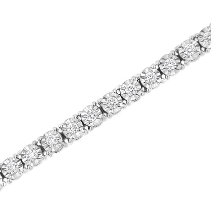 Close-up diagonal view of a white metal bracelet featuring round shaped white gemstones set in a miracle setting.