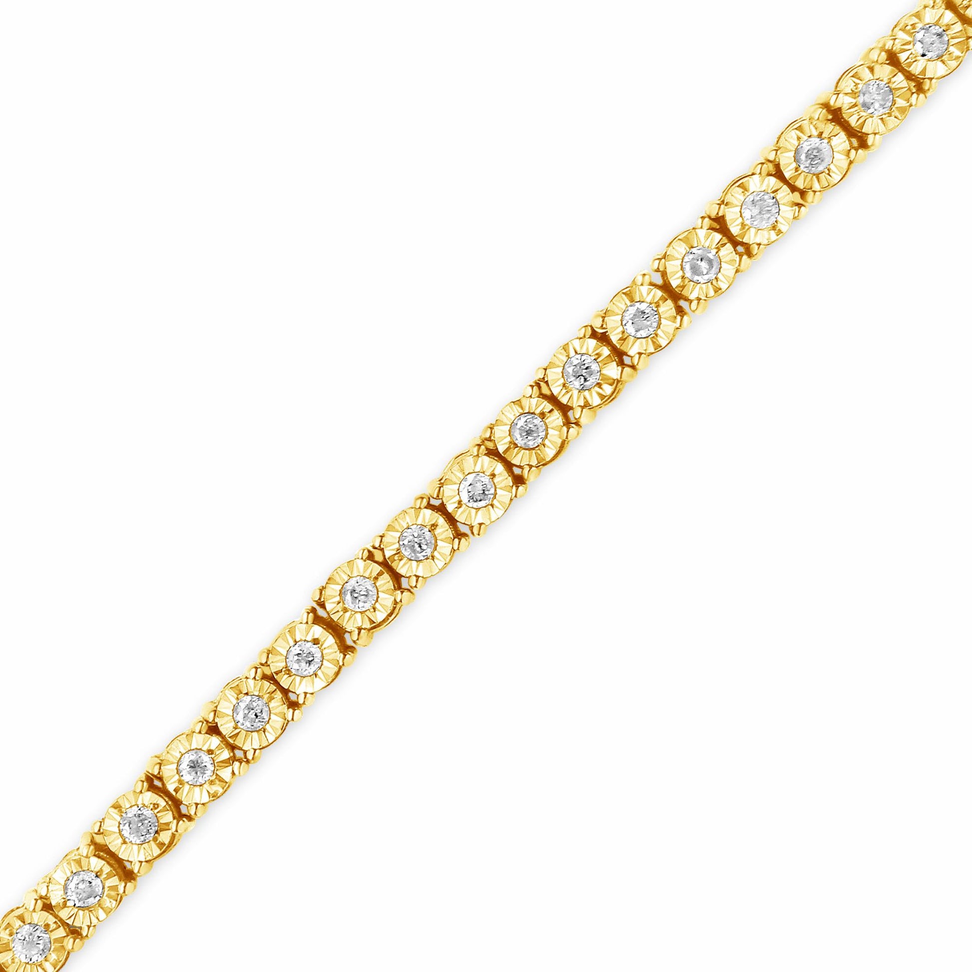 Diagonal close-up of a yellow metal bracelet featuring round white gemstones in a miracle setting along its length on a white background.
