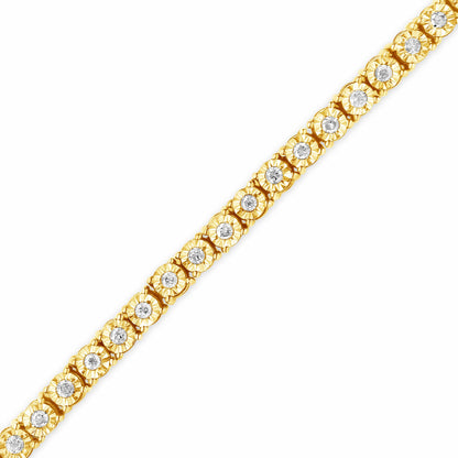 Diagonal close-up of a yellow metal bracelet featuring round white gemstones in a miracle setting along its length on a white background.