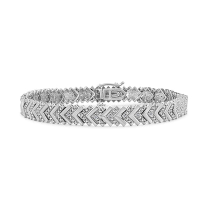 White metal bracelet with alternating chevron shapes adorned with round white gemstones in prong settings, shown from a slightly angled front view.