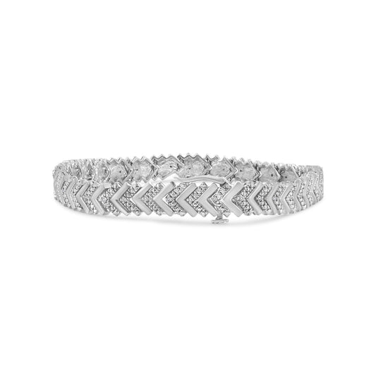 White metal bracelet with round white gemstones in prong settings forming a chevron pattern, shown from a front angle.