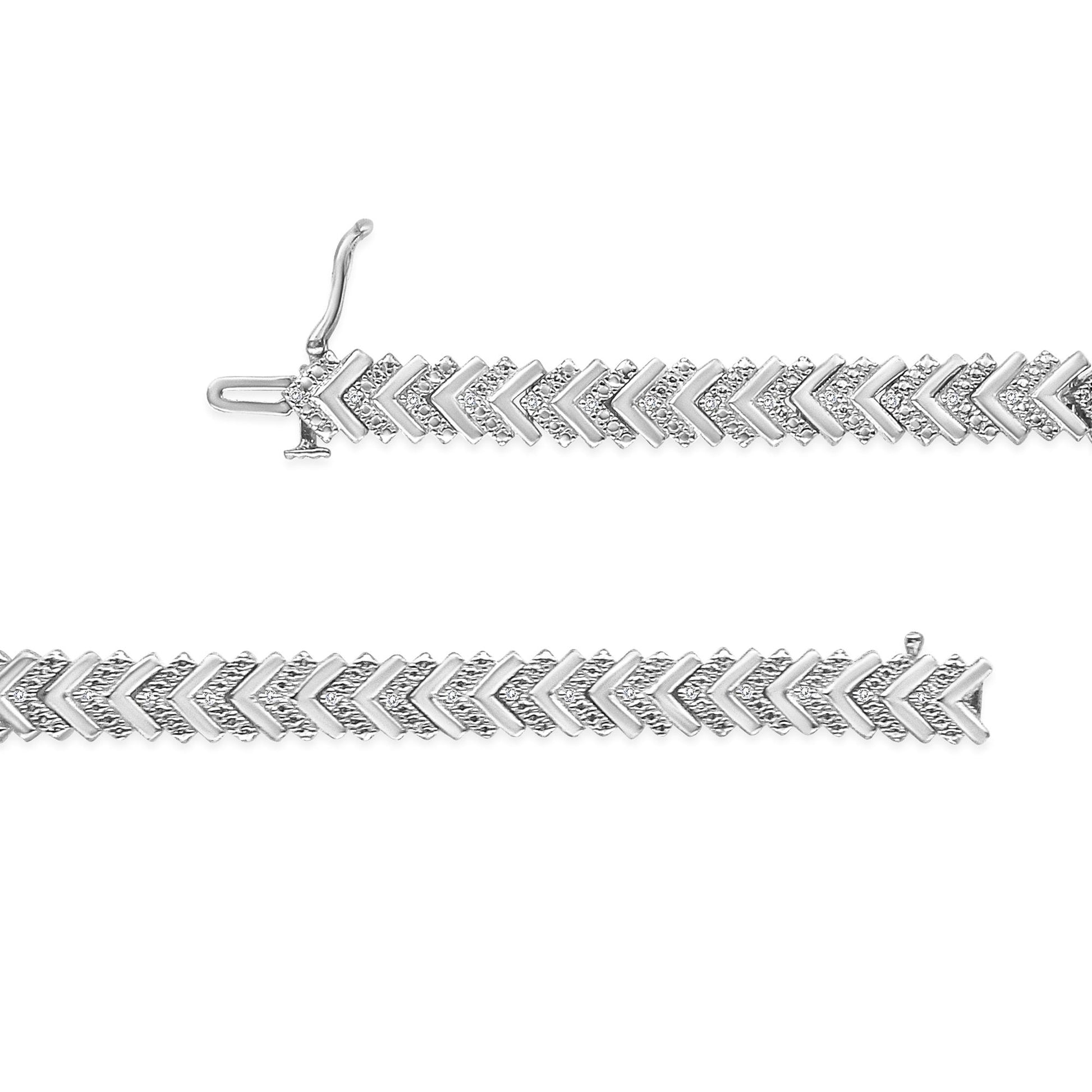 White metal bracelet with alternating chevron links, each set with round white gemstones, shown in a horizontal top-down view.