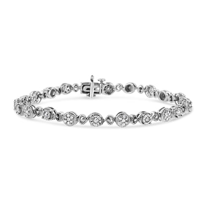 White metal bracelet with round white gemstones in prong and cluster settings, shown from front angle on a white background.