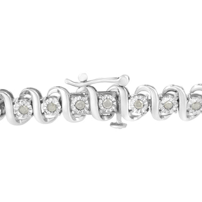 Close-up front angle of a white metal bracelet with a wavy design featuring round white gemstones in a miracle setting, shown clasped.