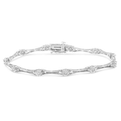 White metal bracelet with round white gemstones in miracle settings along the band, shown in a front angle shot.