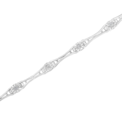 Diagonal close-up of a white metal bracelet featuring round white gemstones in miracle settings along its length.