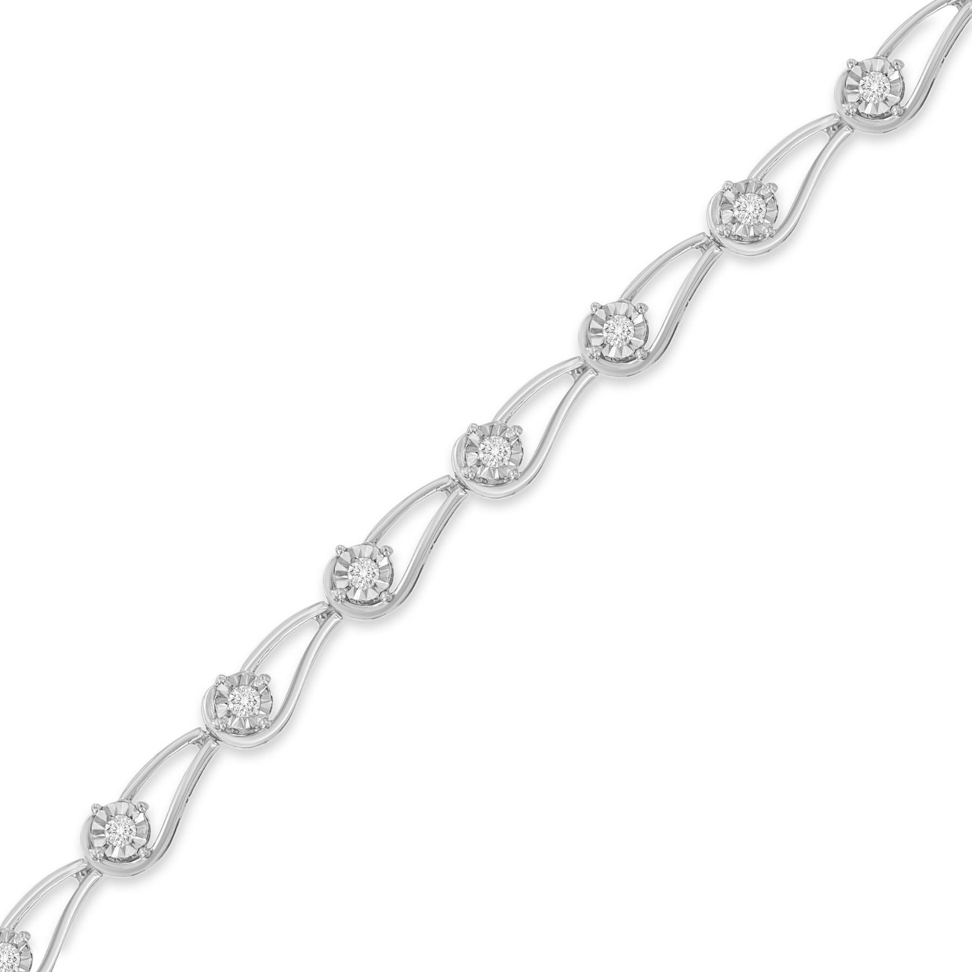 Diagonal close-up of a white bracelet featuring round white gemstones in a miracle setting connected by curved links.