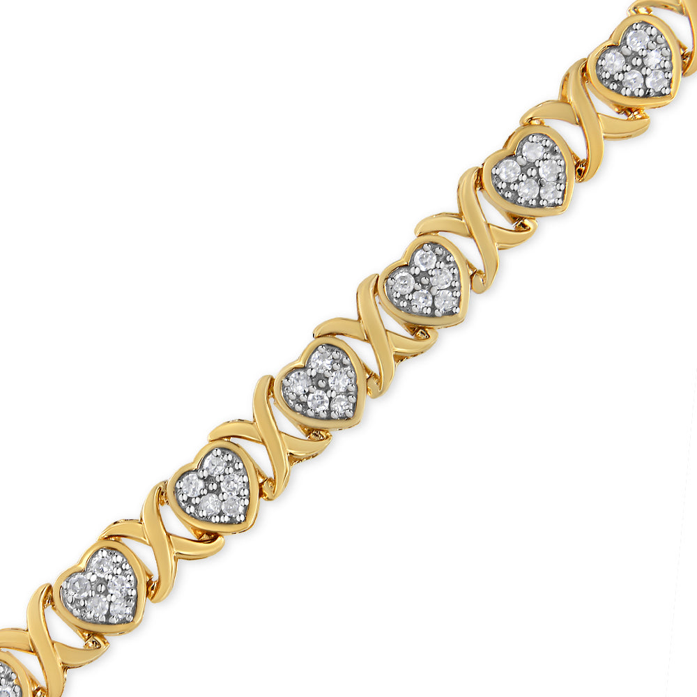 Bracelet shot from a slight angle featuring alternating yellow and white metal hearts with pave-set round white gemstones.