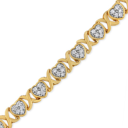 Bracelet shot from a slight angle featuring alternating yellow and white metal hearts with pave-set round white gemstones.