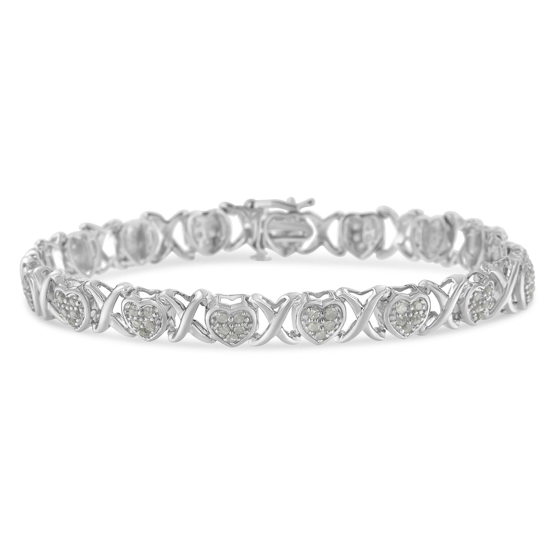 Front-facing shot of a white metal bracelet featuring alternating heart shapes with pave set round white gemstones and X-shaped links.