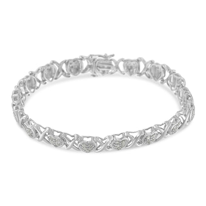 White metal bracelet with heart-shaped links featuring pave-set white gemstones, shown from a slightly elevated angle on a white background.