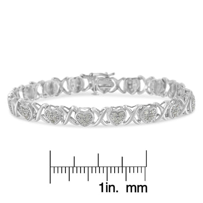 Bracelet with heart-shaped and X-shaped links featuring round white gemstones in a pave setting, shown in a front angle on a ruler for size reference.